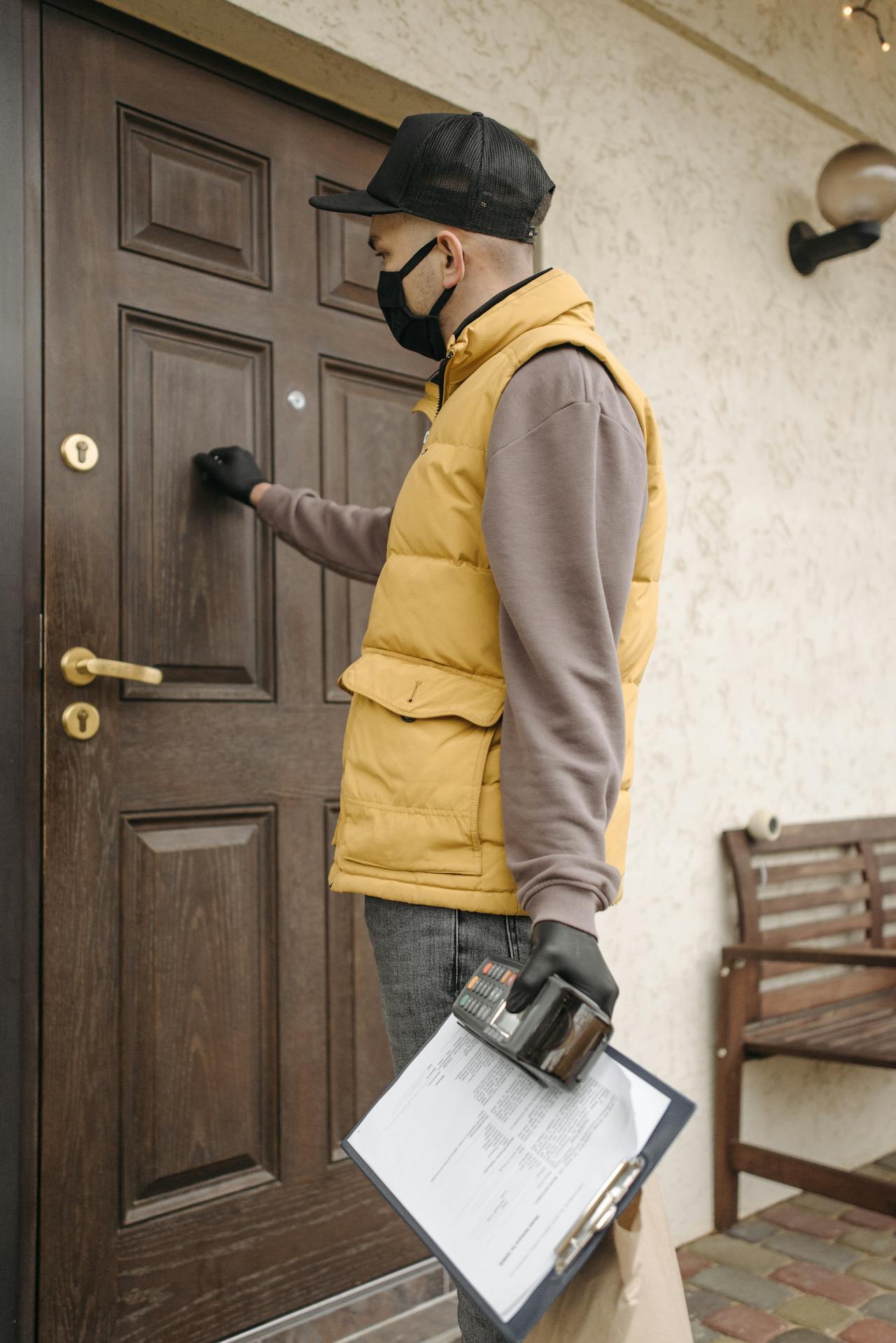 Sales representative knocking on residential door with clipboard
